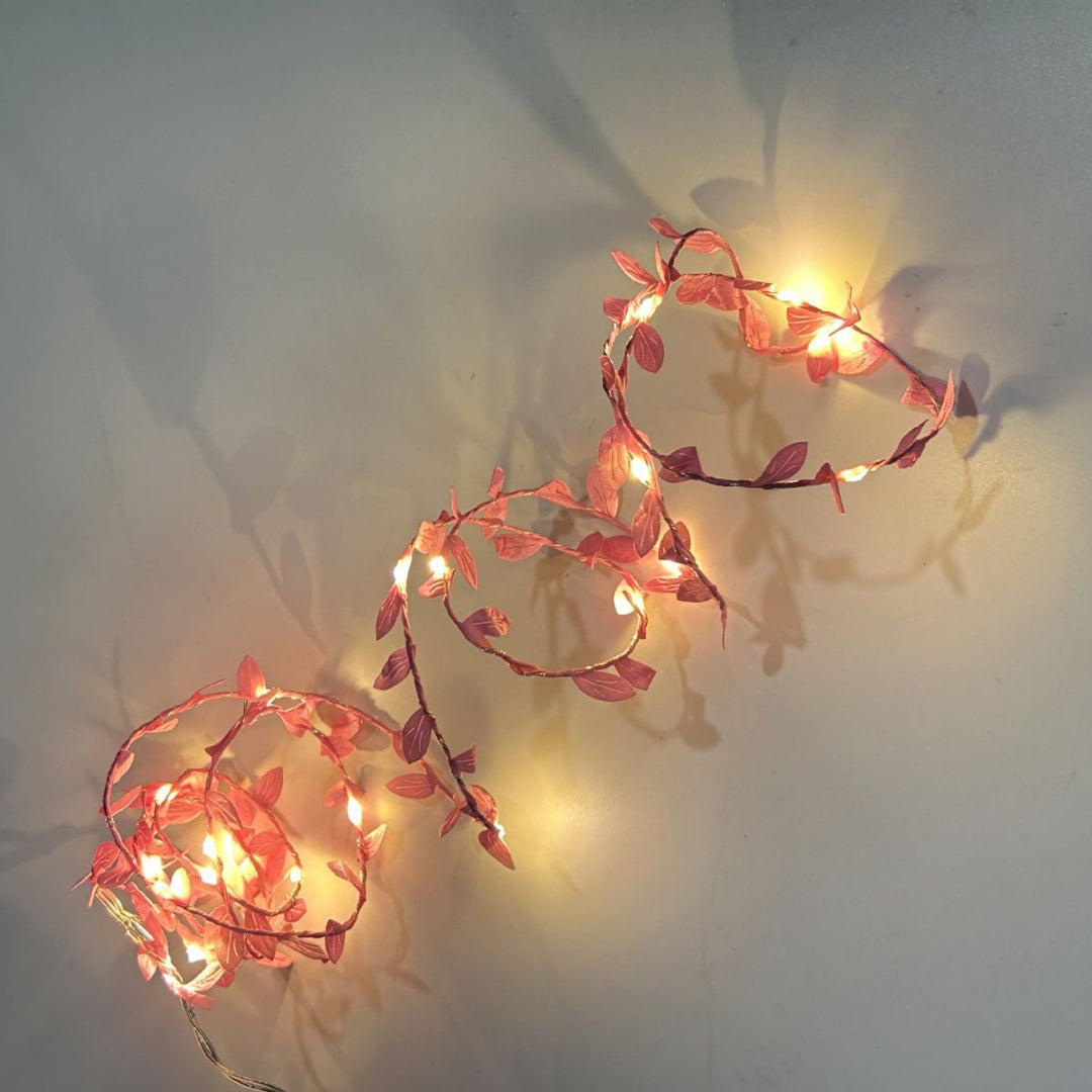 LED light chain with artificial leaves