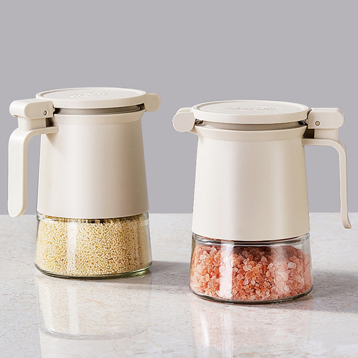 Sealed spice container made of glass with spoon