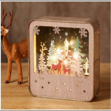 Illuminated wooden house with Christmas motif