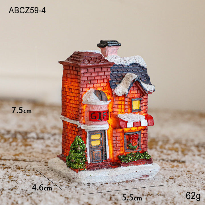 Illuminated Christmas house made of resin for table decoration