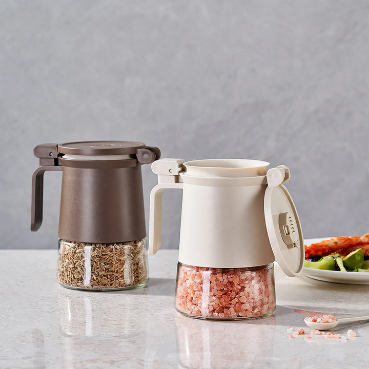 Sealed spice container made of glass with spoon