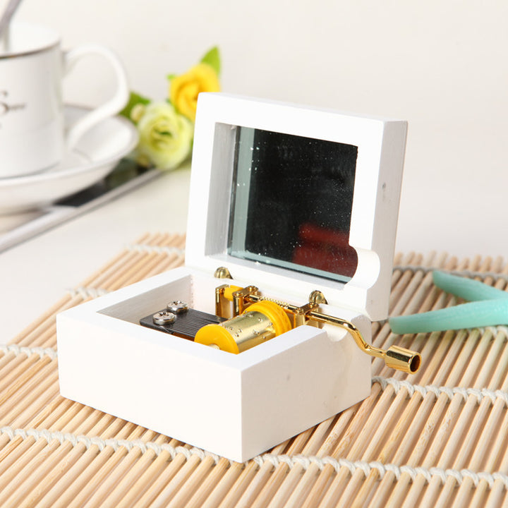 Wooden music box with hand crank