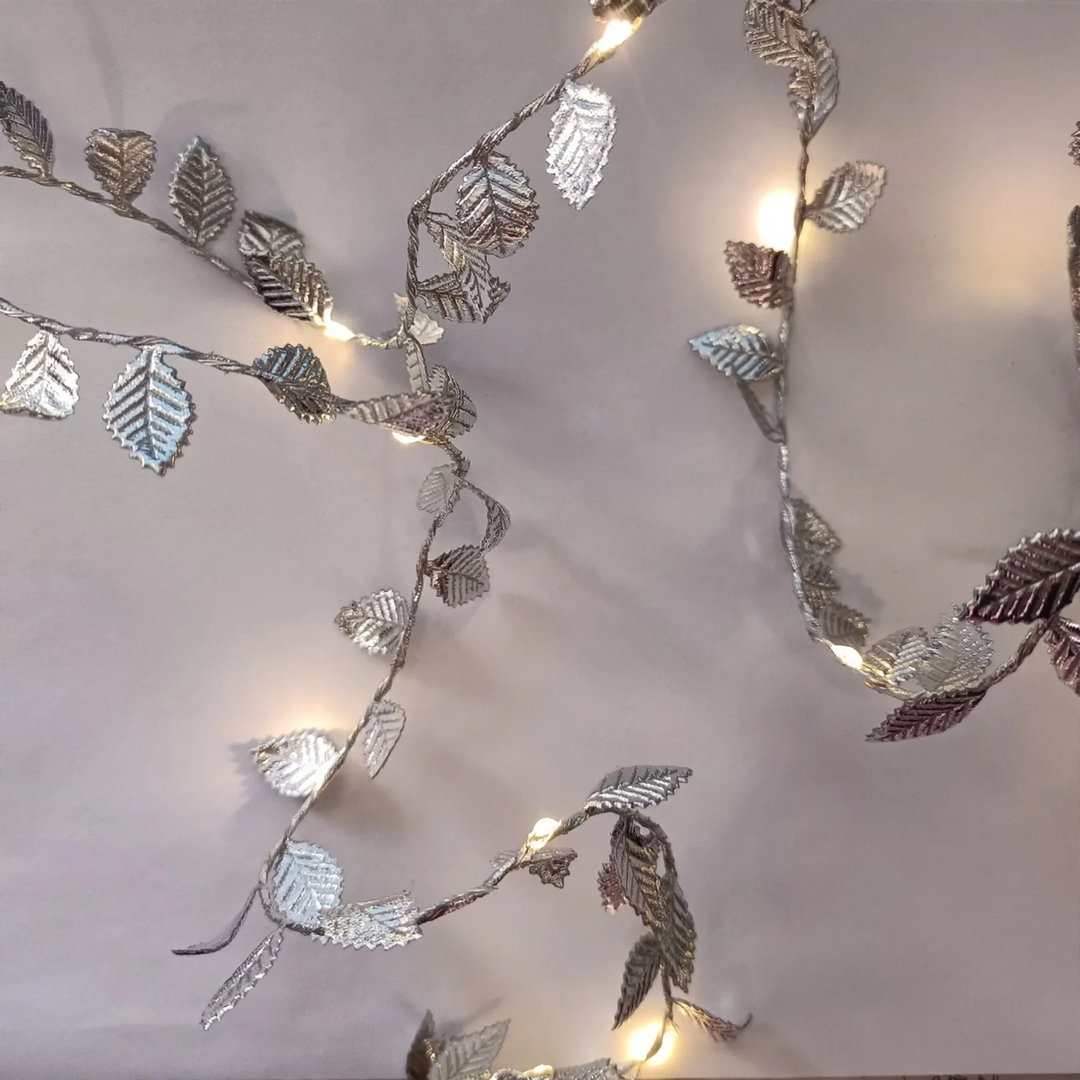 LED light chain with artificial leaves