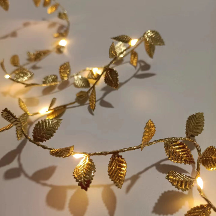 LED light chain with artificial leaves