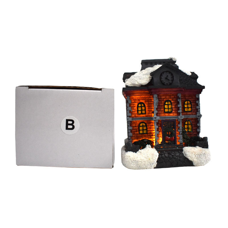 Illuminated Christmas house made of resin with snow effect