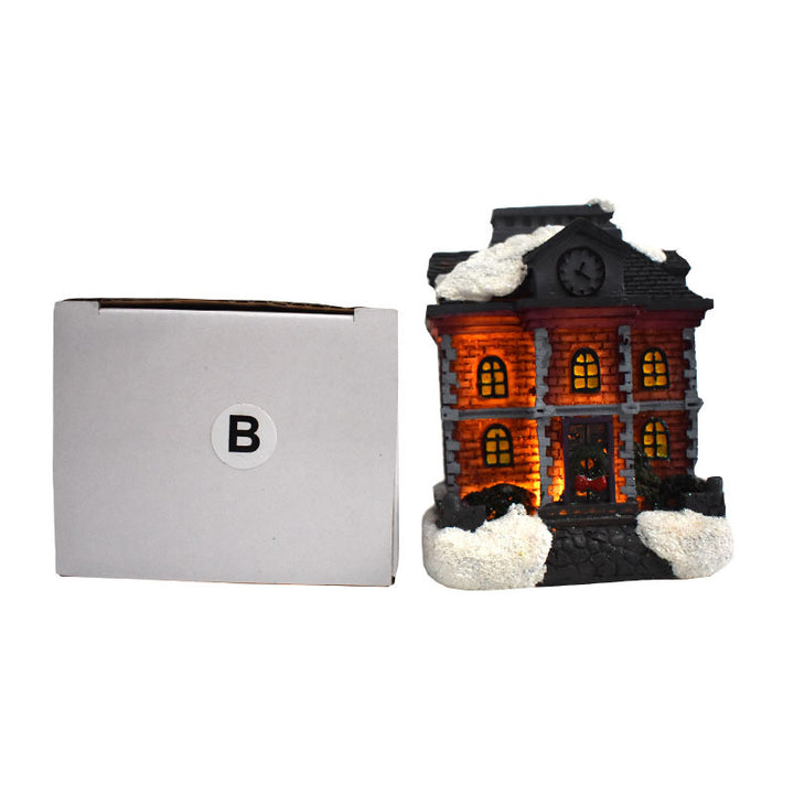 Illuminated Christmas house made of resin with snow effect