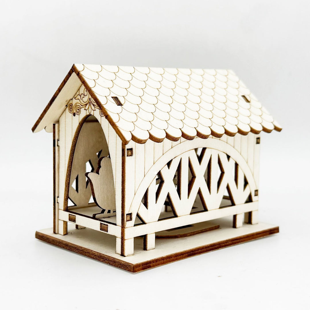 Illuminated wooden house with bridge