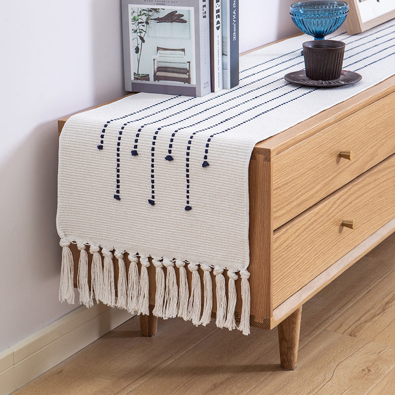 Decorative table runner in Scandinavian-minimalist design with macrame fringes Stornfield