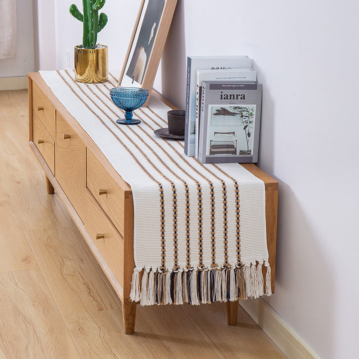 Decorative table runner in Scandinavian-minimalist design with macrame fringes Stornfield