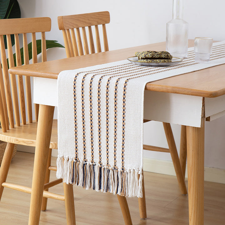 Decorative table runner in Scandinavian-minimalist design with macrame fringes Stornfield