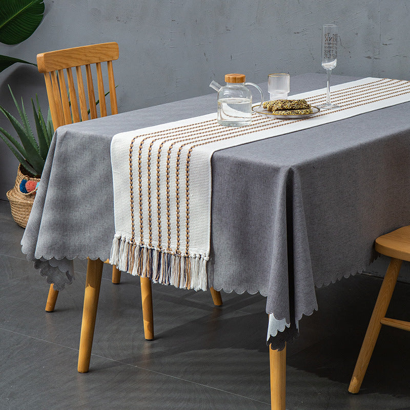 Decorative table runner in Scandinavian-minimalist design with macrame fringes Stornfield