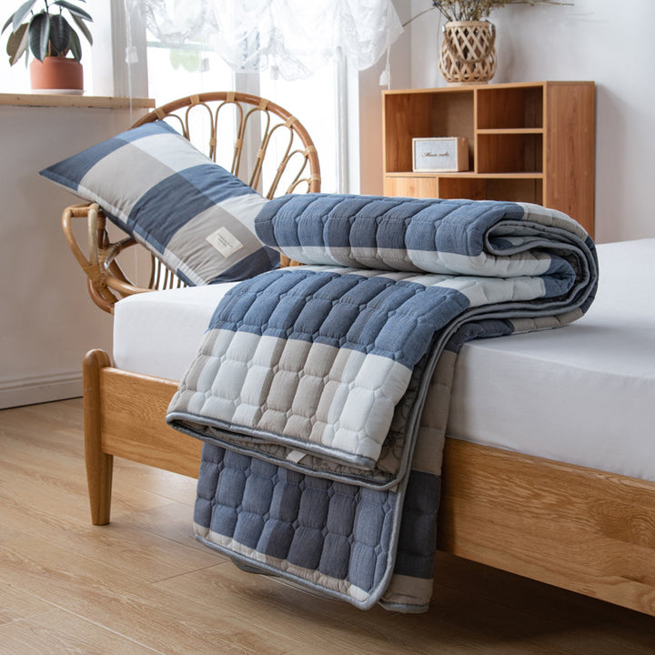 Padded mattress protector-topper with quilting and non-slip underside