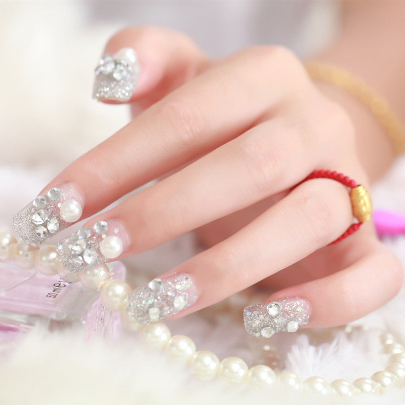 Art nails with glitter and pearl accents Stornfield