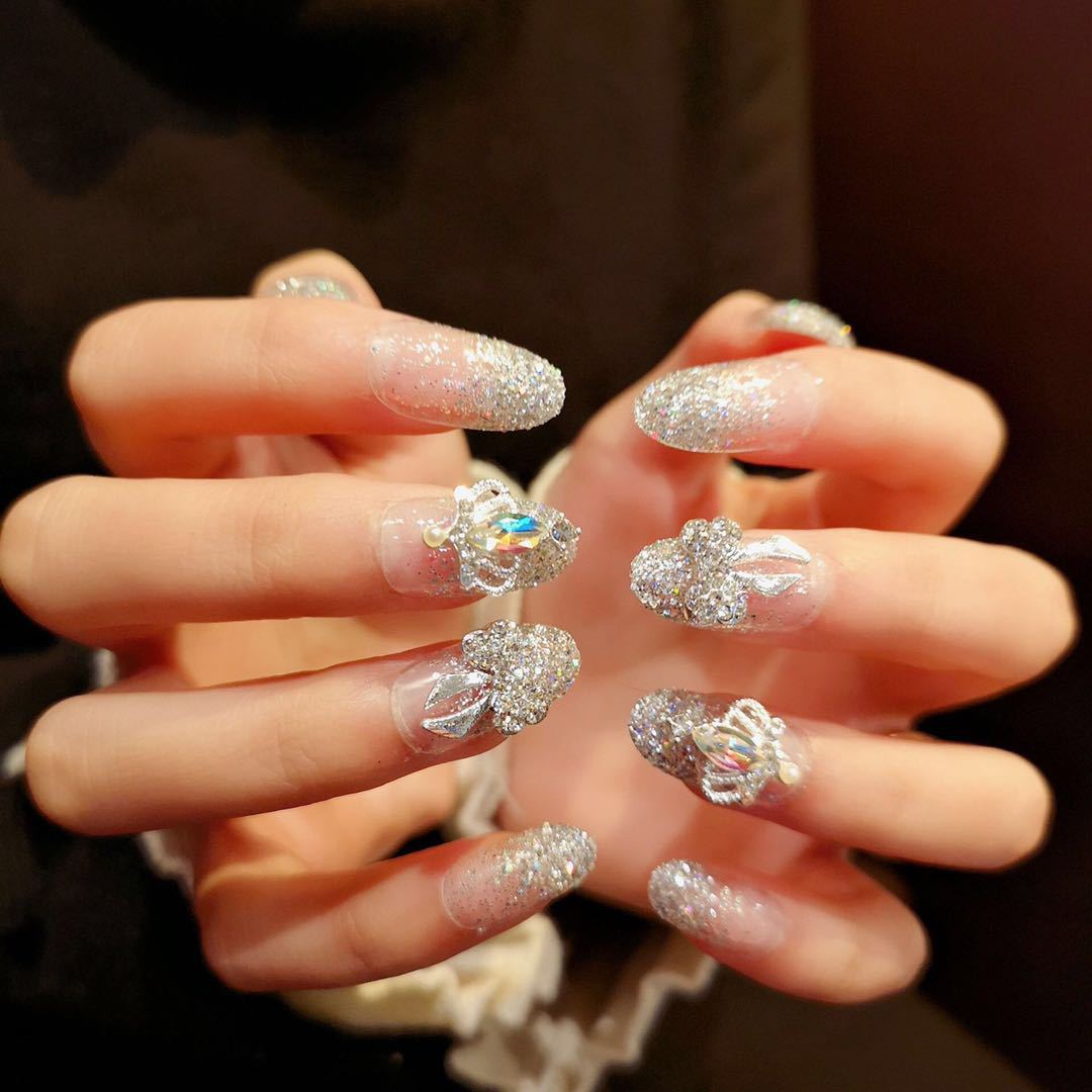 Nail art with sparkling rhinestone and glitter accents Stornfield