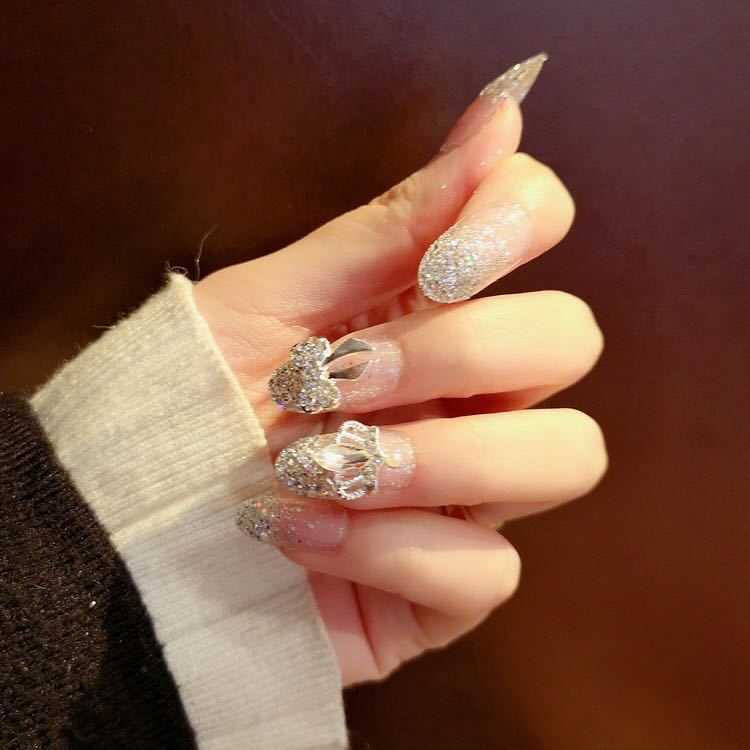 Nail art with sparkling rhinestone and glitter accents Stornfield