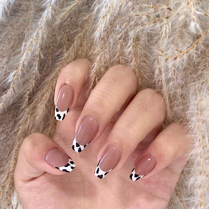 Stylish nail extensions in modern cow print style Stornfield