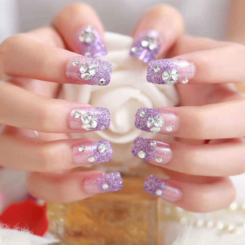 Artificials nails with sparkling rhinestone accents and elegant flower embellishments Stornfield