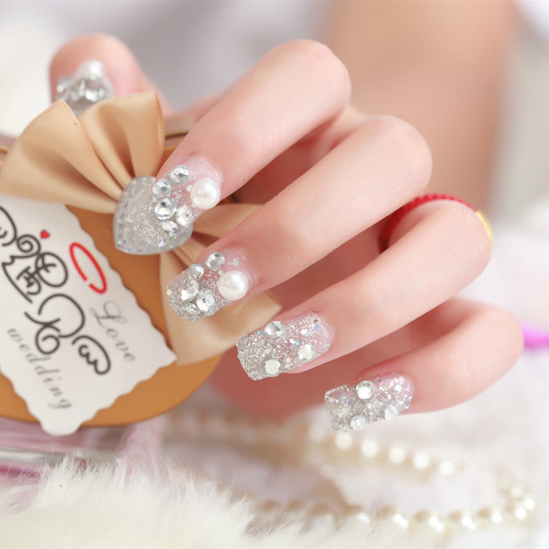 Art nails with glitter and pearl accents Stornfield