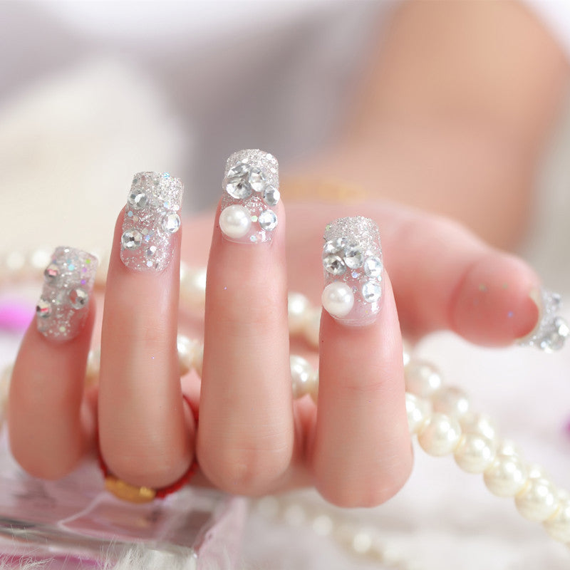 Art nails with glitter and pearl accents Stornfield
