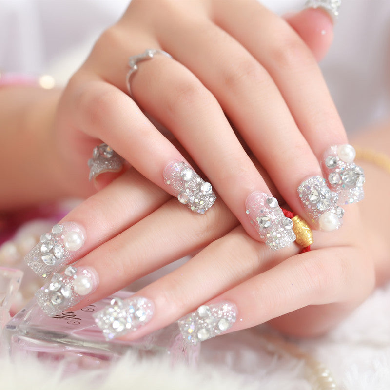 Art nails with glitter and pearl accents Stornfield