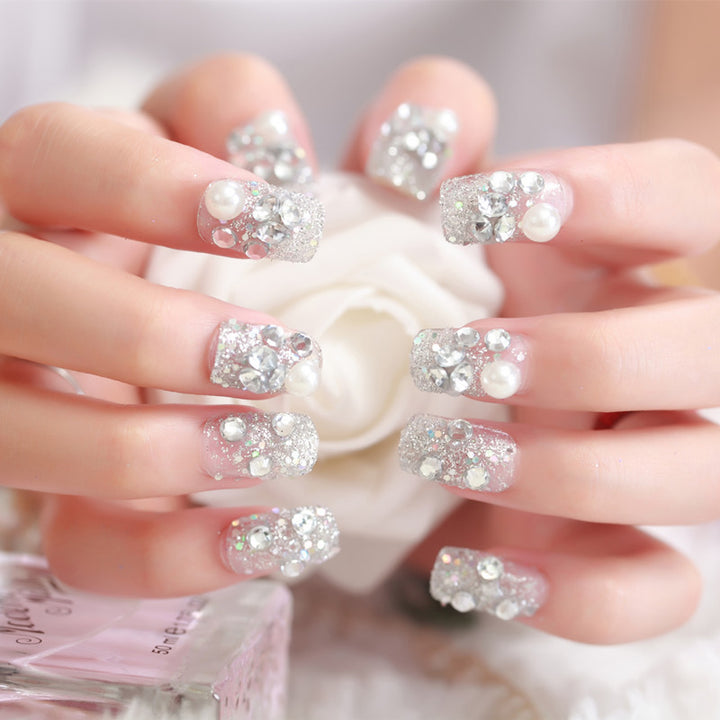 Art nails with glitter and pearl accents Stornfield