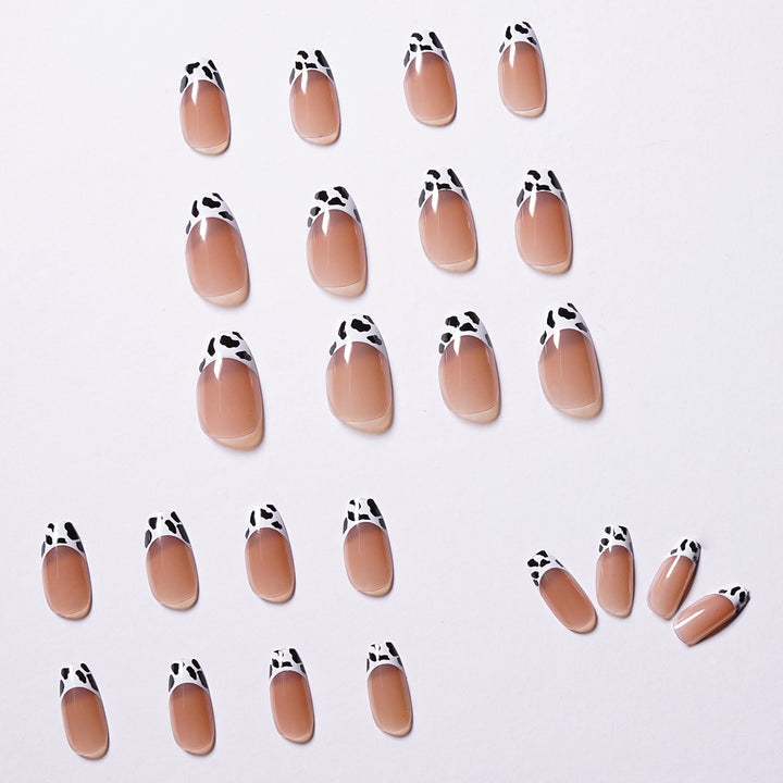 Stylish nail extensions in modern cow print style Stornfield