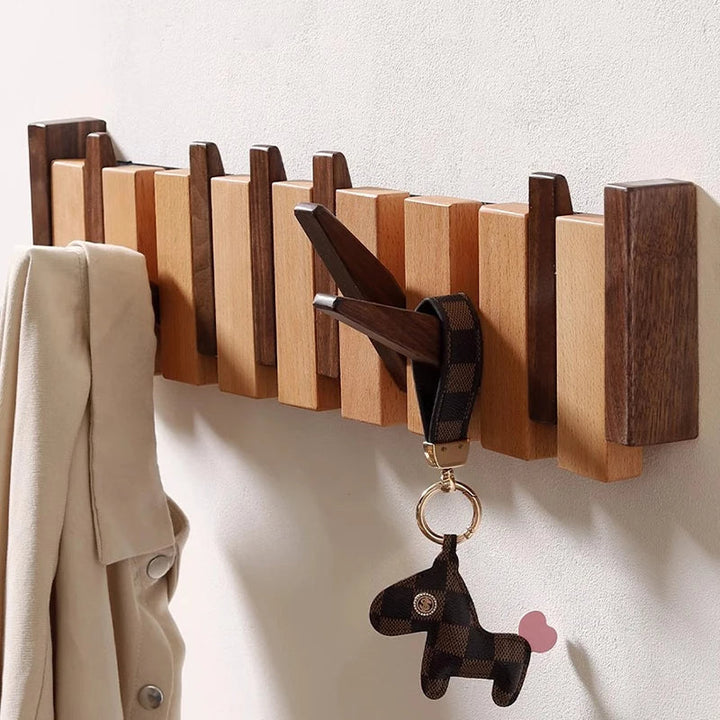 Wooden coat rack in piano design with foldable hooks | Stornfield