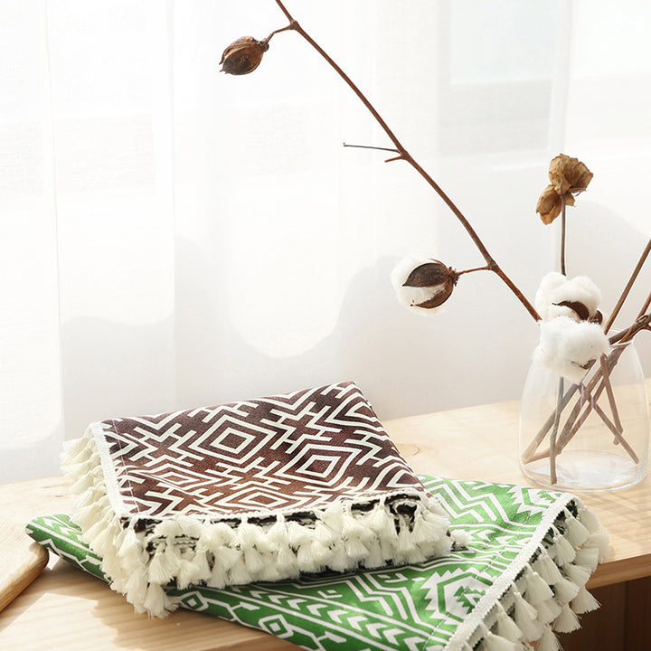 Woven cotton tablecloth with ethnic jacquard pattern and tassel trim