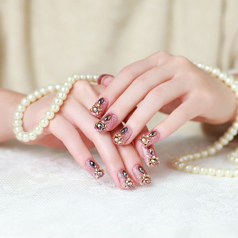 Glamorous artificial nails with glitter and jewelry decoration Stornfield