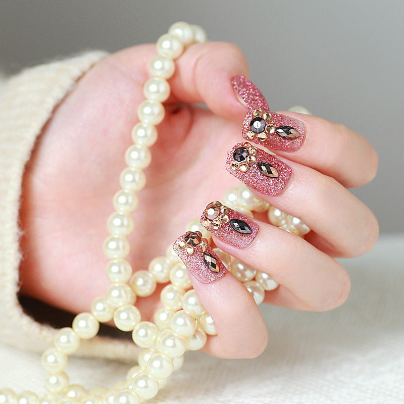 Glamorous artificial nails with glitter and jewelry decoration Stornfield