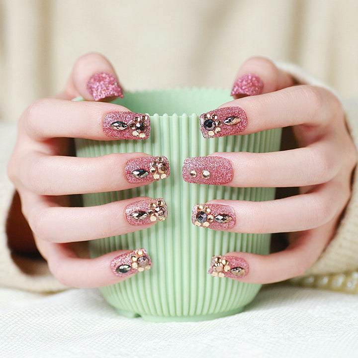 Glamorous artificial nails with glitter and jewelry decoration Stornfield