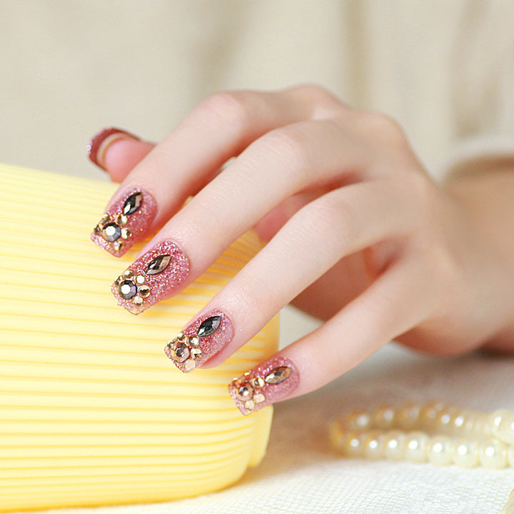 Glamorous artificial nails with glitter and jewelry decoration Stornfield