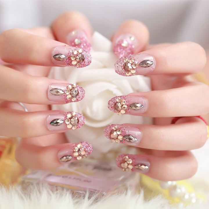 Glamorous artificial nails with glitter and floral elements Stornfield