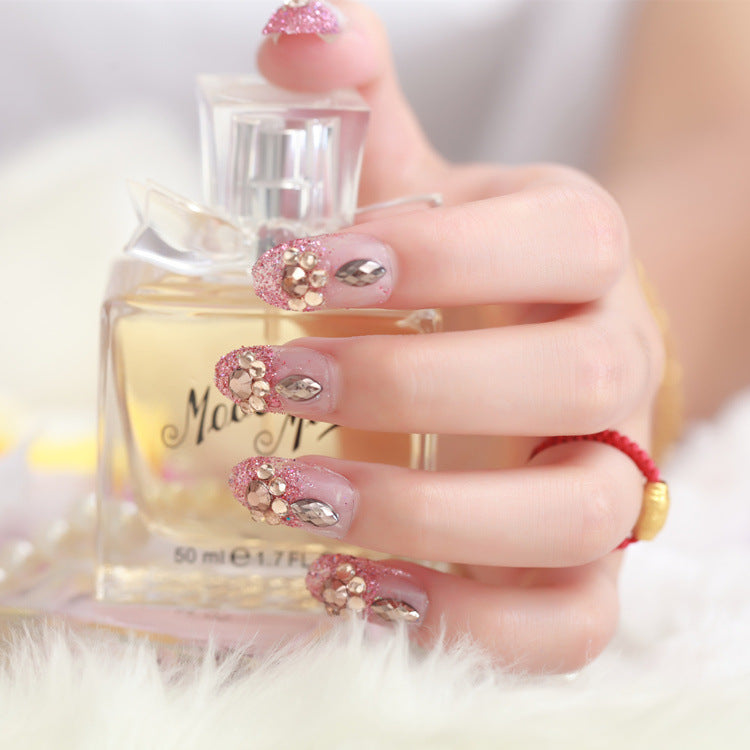 Glamorous artificial nails with glitter and floral elements Stornfield