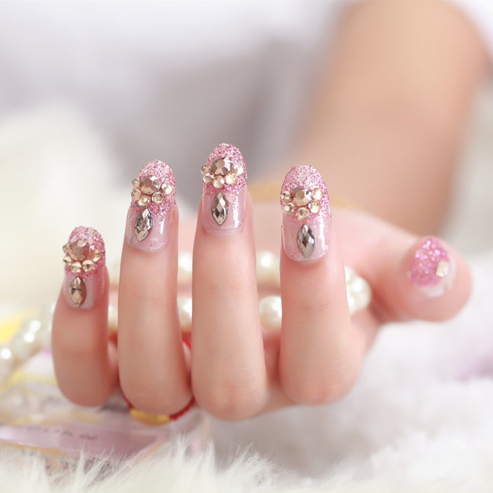 Glamorous artificial nails with glitter and floral elements Stornfield