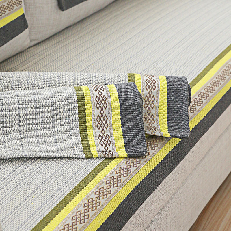 Handwoven table runner made of cotton blend with woven decorative border and striped texture