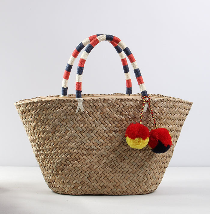 Braided beach bag with decorative pompons Stornfield