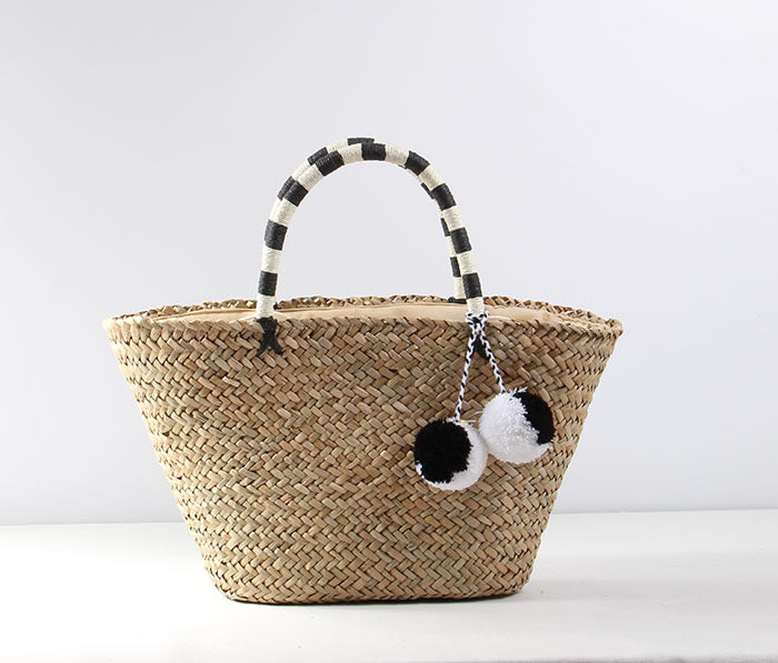 Braided beach bag with decorative pompons Stornfield