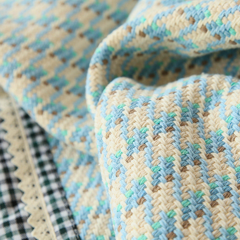 Handwoven breathable mattress topper with checkered decorative ribbon