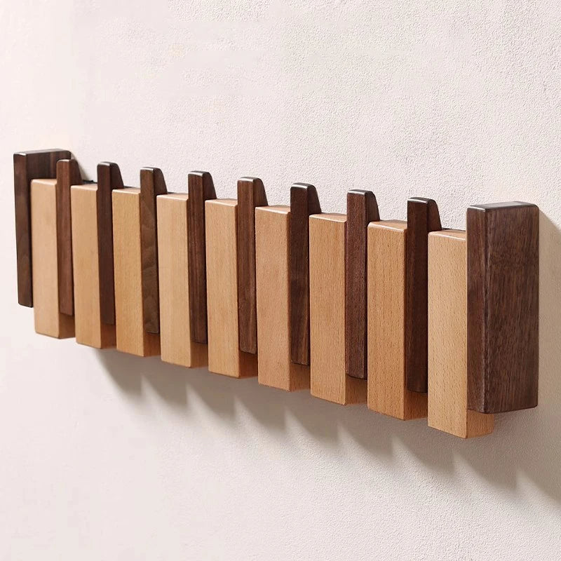 Wooden coat rack in piano design with foldable hooks | Stornfield