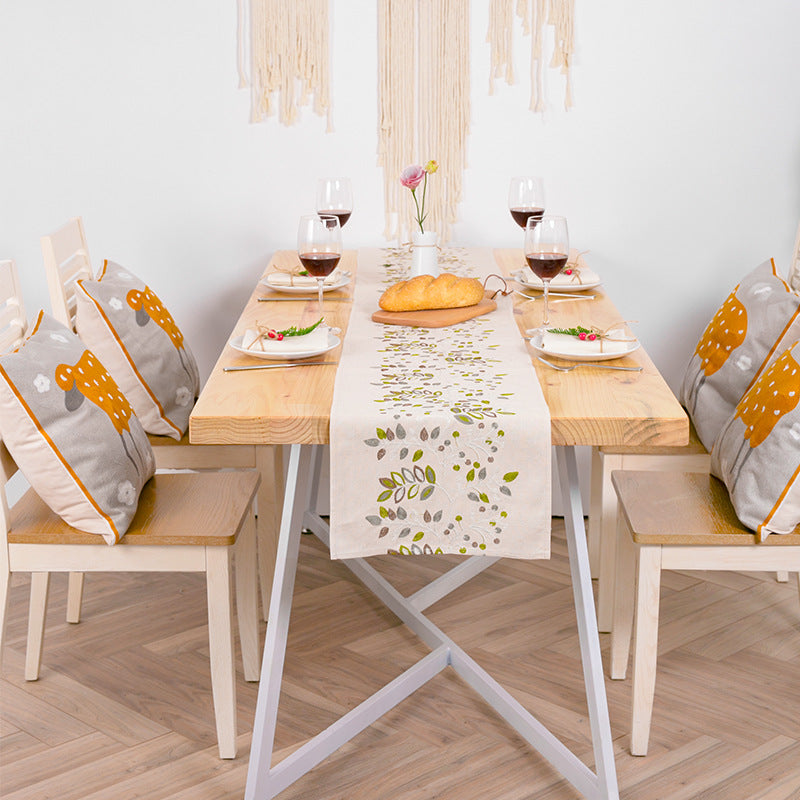 Decorative table runner made of a cotton-linen blend with botanical leaf print
