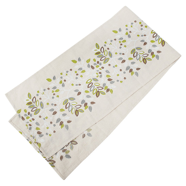 Decorative table runner made of a cotton-linen blend with botanical leaf print