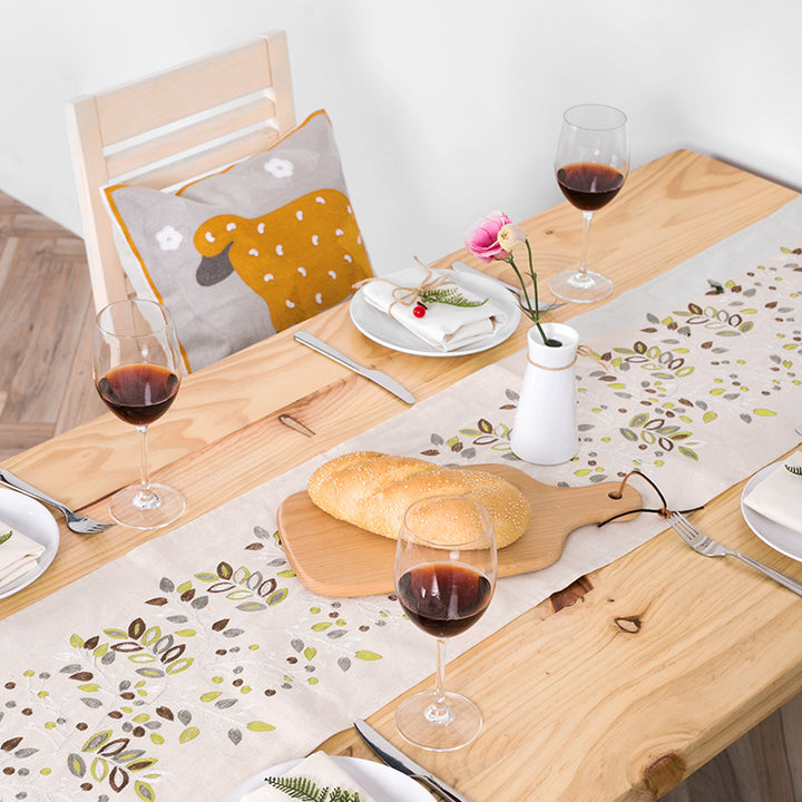 Decorative table runner made of a cotton-linen blend with botanical leaf print