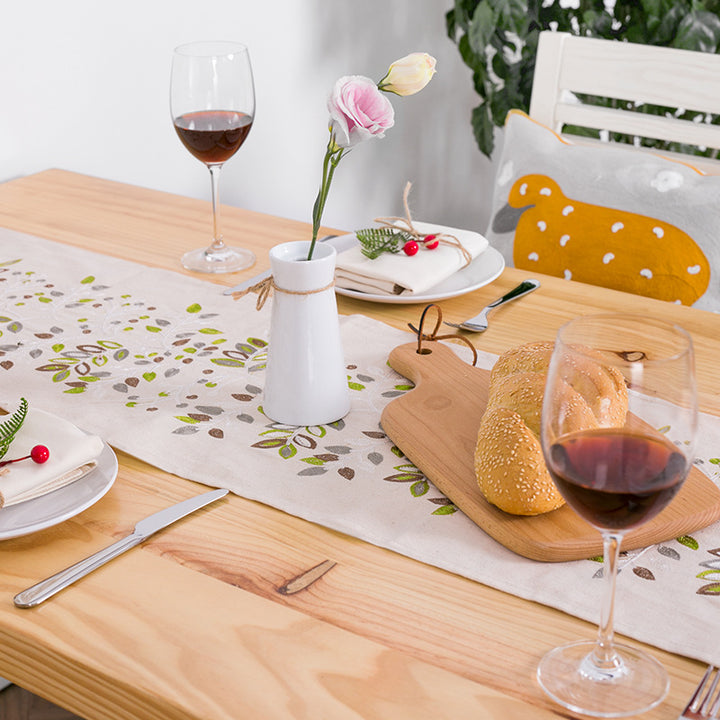Decorative table runner made of a cotton-linen blend with botanical leaf print