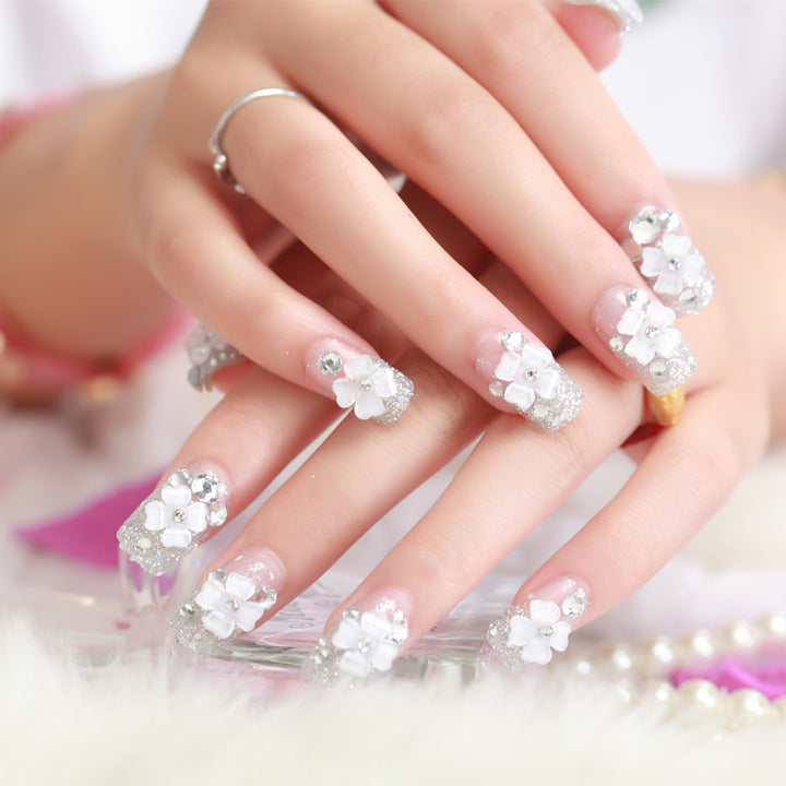 Artificial nails with glitter and floral 3D accents Stornfield
