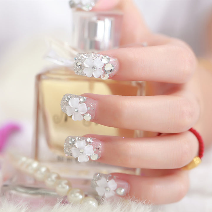 Artificial nails with glitter and floral 3D accents Stornfield