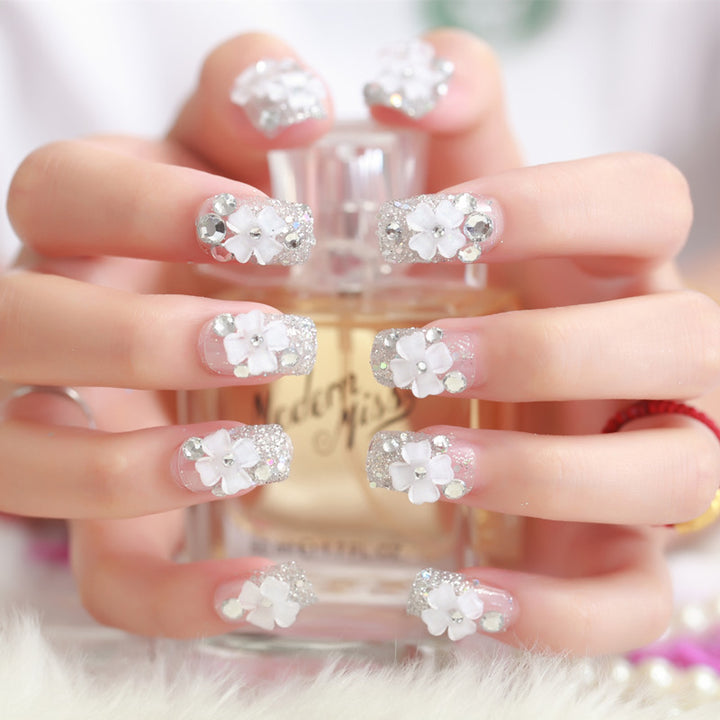 Artificial nails with glitter and floral 3D accents Stornfield