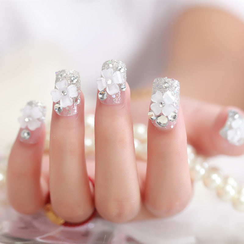 Artificial nails with glitter and floral 3D accents Stornfield