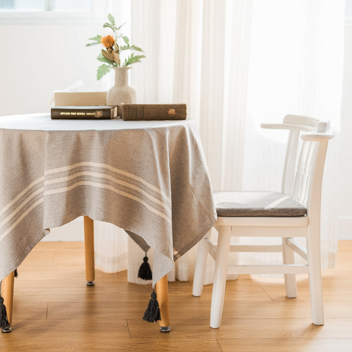 Rectangular linen look tablecloth with fringed tassels and side stripe border design Stornfield