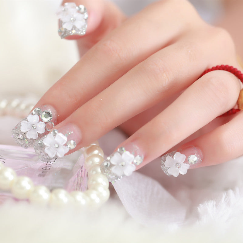Artificial nails with glitter and floral 3D accents Stornfield